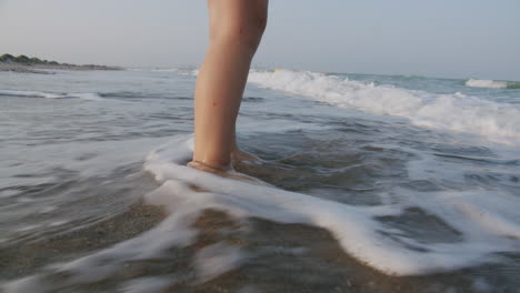 Girl-feet-in-the-ocean-waves