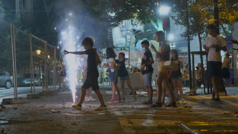 Children-celebrating-Fallas-with-fountain-firework-in-night-city