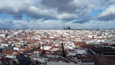 Aerial-shot-of-Madrid-housing-areas-clouds-sailing-over-the-city