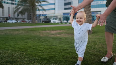 In-the-summer-a-young-mother-walking-with-a-child-along-the-promenade.