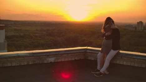 Romantic-date-on-the-roof.-Loving-couple-dating-on-the-roof-at-the-sunset