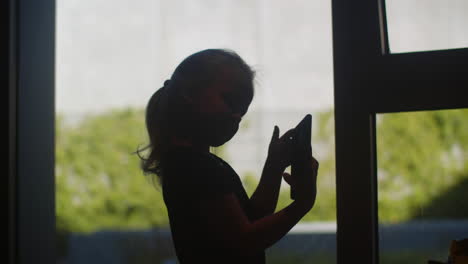Child-playing-with-phone-and-posing-for-selfie