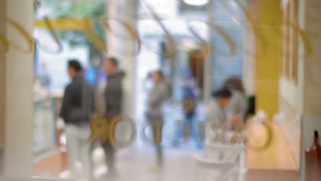 Cafeteria-guests-waiting-in-queue-blurry-view-through-the-glass