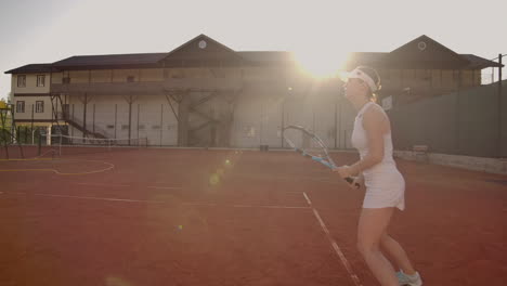 Tennis-game-on-sunny-day-at-tennis-court-young-sportive-woman-playing-professional-tennis.-Tennis-game-on-sunny-day