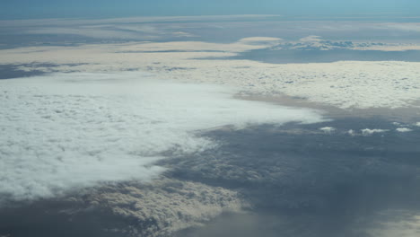 Plane-flies-over-the-clouds-in-the-sky