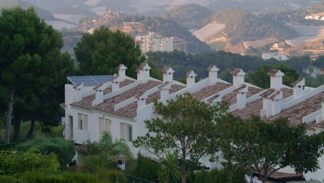 Apartment-house-with-solar-energy-panel-against-hilly-scenery-in-Polop-Spain