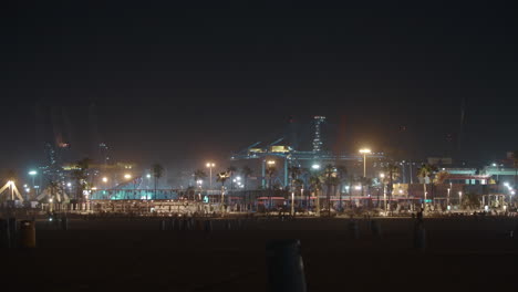 Night-view-of-city-beach-industrial-cranes-and-concert-lights