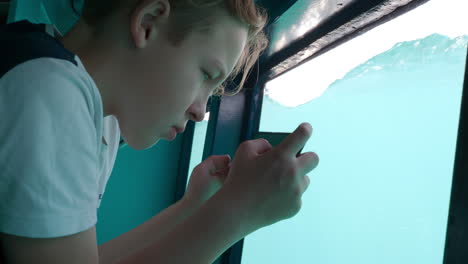 Teenager-in-a-boat-with-a-glass-side