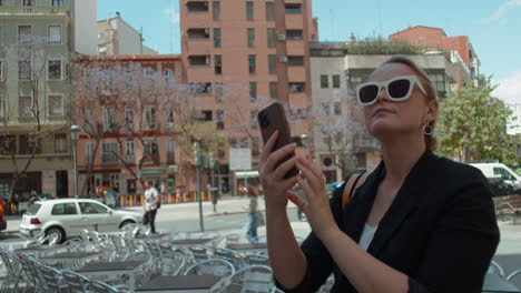 A-young-woman-is-taking-photos-with-her-mobile-phone