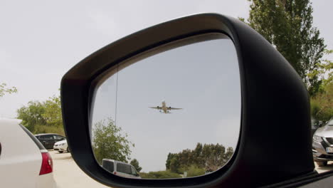 Reflected-aircraft-in-the-rearview-mirror-of-the-car