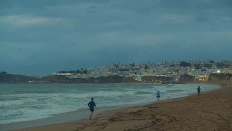 Evening-ocean-waves-and-city-lights-in-portugal
