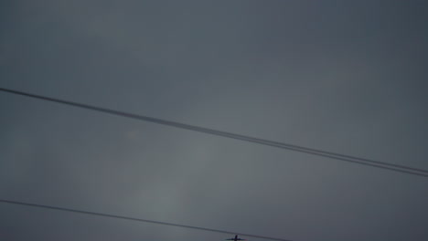 Passenger-plane-flies-over-power-lines