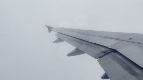 Der-Flügel-Eines-Fliegenden-Flugzeugs-Inmitten-Dichter-Wolken