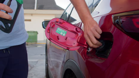 Anonymous-male-driver-refueling-car