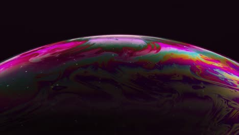 Abstract-Concept-The-Multicolored-Iris-of-a-Soap-Bubble-is-in-Motion-Rainbow-Bubble-on-a-Dark