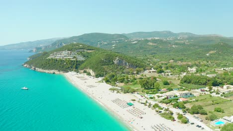 Aerial-wide-view-of-Karavostasi-Beach's-Idyllic-Scenery-toward-Elix-Mar-Bella-Resort,-Greece