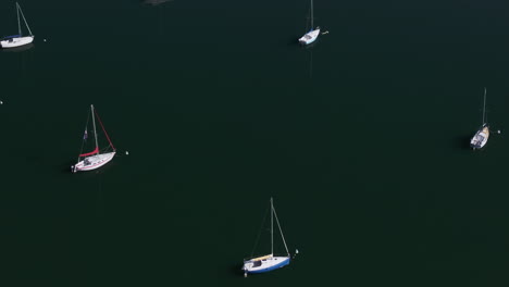 Sailboats-docked-Lake-Dillon-Marina-Colorado-sailboats-early-fall-colors-aerial-cinematic-drone-morning-view-Frisco-Breckenridge-Silverthorne-Ten-Mile-Range-calm-reflective-water-circle-right-motion