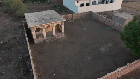 Aerial-drone-top-down-shot-over-village-houses-and-boundary-wall-in-Mirpurkhas,-Pakistan-during-evening-time