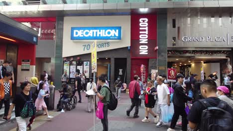 People-entering-and-exiting-Mong-Kok-train-station,-Hong-Kong,-China