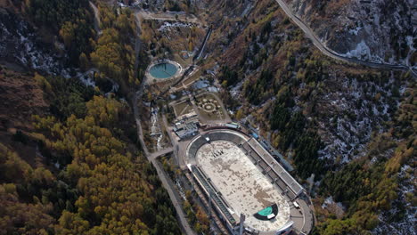 Aerial-view-tilting-over-the-Medeu-stadium,-sunny,-autumn-day-in-Kazakhstan