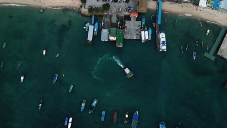 Aerial-top-down-of-koh-tao-ferry-port-in-Thailand-South-east-Asia,-boat-moored-at-bay-waiting-for-tourist