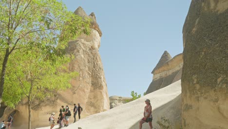 Tourists-explore-unique-rocky-fairy-chimney-landscape-Cappadocia