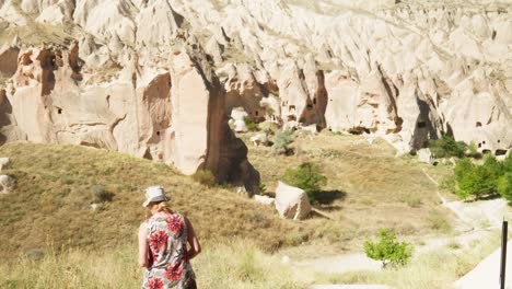 Woman-tourists-photographs-rocky-fairy-chimney-landscape-Cappadocia