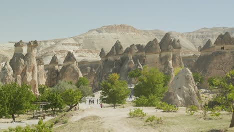 Zelve-tourists-explores-rocky-fairy-chimney-landscape-Cappadocia
