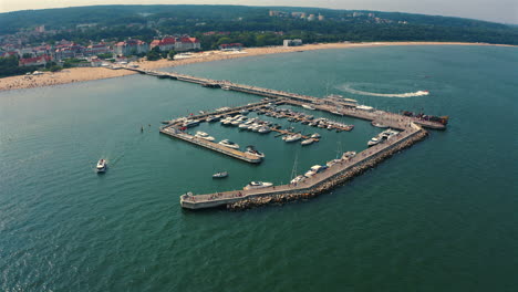 Aerial-view-of-the-marina-with-moored-luxurious-yachts-and-motorboats-at-sunny-summer-day