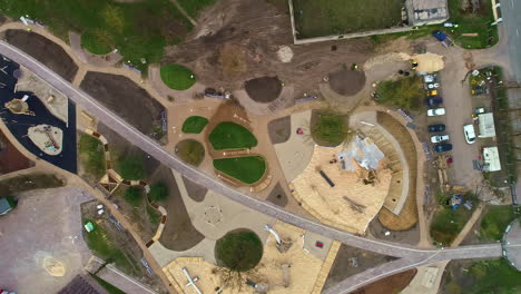 Landscaping-a-park,-playground-and-public-green-space-in-a-city---descending-straight-down-aerial-view