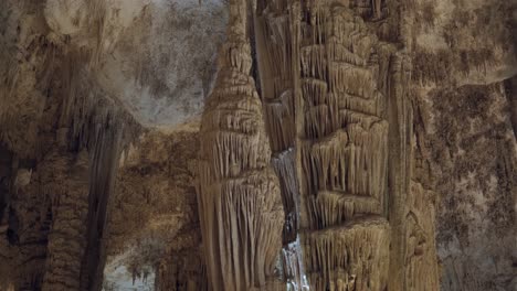 Several-tourists-taking-photographs-of-giant-columns-produced-by-stalactites-in-the-Neptune-grottoes