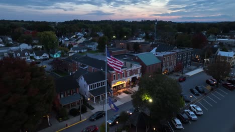 Small-town-square-with-American-flag-at-dusk