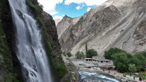 Visitors-at-Mantoka-Waterfall,-Skardu,-Pakistan.-Aerial-flyover