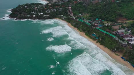 aerial-view-Many-tourists-are-seen-on-the-beach-and-big-waves-are-coming-in-the-water