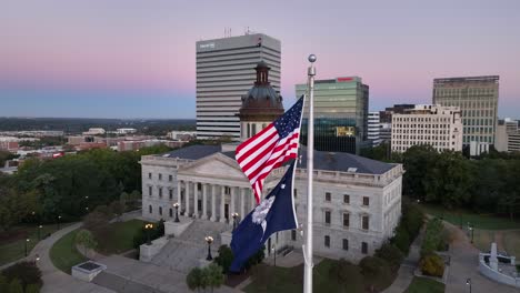 Casa-Del-Estado-De-Carolina-Del-Sur-Con-Banderas-Americanas-Y-Sc-Ondeando-Frente-Al-Horizonte-De-Columbia-Durante-El-Amanecer