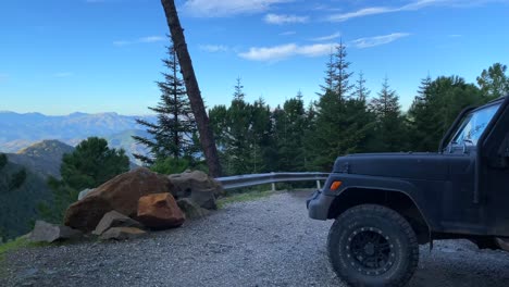 Cool-black-Jeep-4x4-car-with-green-nature-and-forest-view-around-on-Sierra-Bermeja-mountain,-fun-ATV-adventures-on-a-sunny-day-in-Marbella-Malaga-Spain,-4K-shot