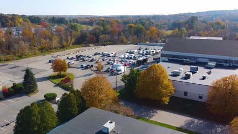 Aerial-overview-above-parking-lot-as-emergency-personell-gather-and-prepare-to-respond-to-mass-shooting-incident