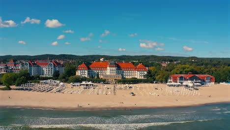 Drone-flying-towards-the-majestic-Grand-Hotel-in-Sopot,-Poland