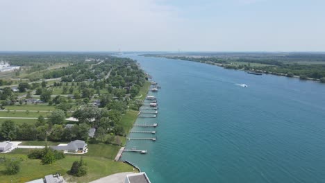 St-Clair-River-with-private-estates-and-boat-in-middle,-aerial-drone-view