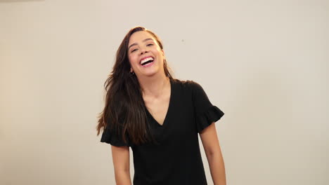 Young-woman-laughing-out-loud-and-smiling