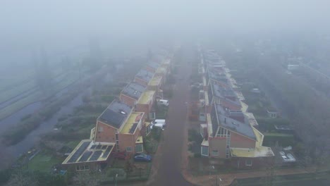Beautiful-aerial-of-a-suburban-street-covered-in-mist