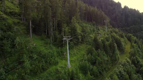 Tall-pole-of-a-rope-way-leading-up-a-mountain-in-the-Alps-in-Lofer,-Austria