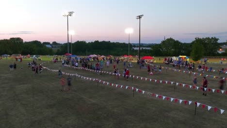 Timelapse-of-people-spectating-high-school-cross-country-race-in-USA-during-sunset