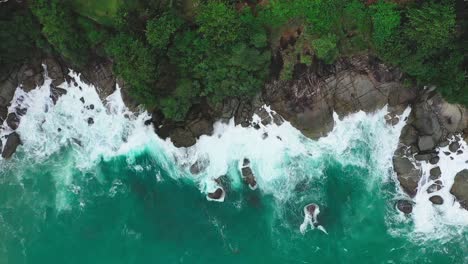 aerial-view-Waves-of-water-hitting-rocks-and-going-back