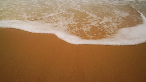 Ocean-Wave-On-Sandy-Beach.