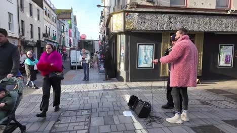 Winter-morning-Oliver-Plunkett-street-in-Cork-City,-with-pedestrians,-busker,-shops,-etc