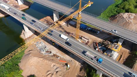 Heavy-traffic-and-construction-site-of-A1-middle-bridge-in-Kaunas,-aerial-orbit-view