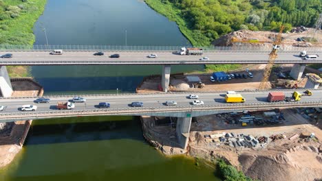 Constructing-new-highway-bridge-over-Neris-River-in-Kaunas,-aerial-view