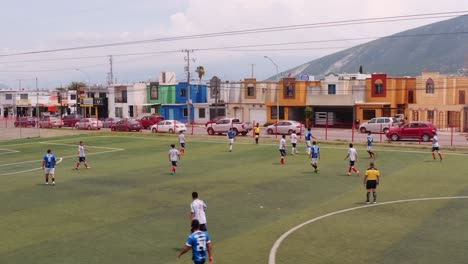 Aerial-view-circling-Mexican-soccer-teams-playing-match-in-Monterrey,-Northern-Mexico