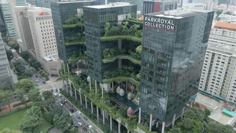 Aerial-dolly-shot-of-a-green-high-rise,-ParkRoyal-is-a-iconic-eco-friendly-and-stunning-hotel-in-a-garden-concept-that-incorporates-energy-saving-features-and-environmentally-friendly-technologies